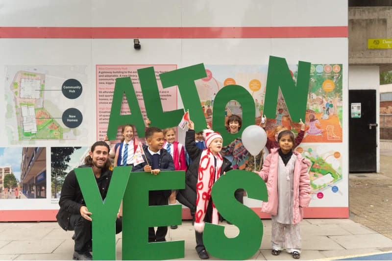 Aydin Dikerdem and children hold up letters saying ALTON YES
