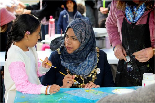 Child painting with Wandsworth Mayor