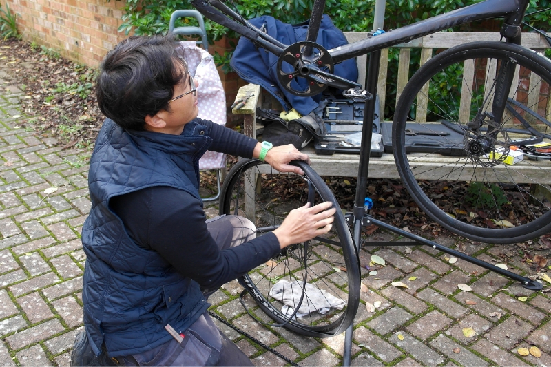 A volunteer repairs a bike during a repair cafe session